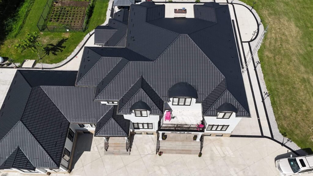 Drone view of Metal tile roof installed on detached home.