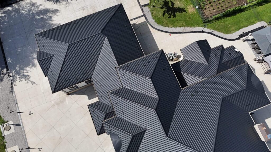 Drone view of dark metal tile roof installation in GTA