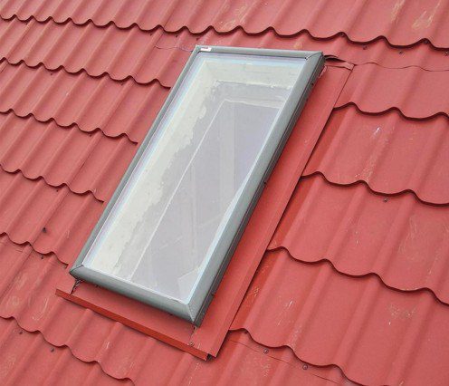 Skylight replacement with red metal tile roof installation