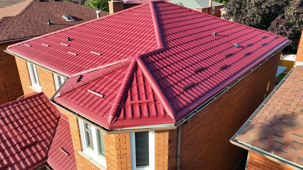 Red metal tile roof installation on residential home in GTA